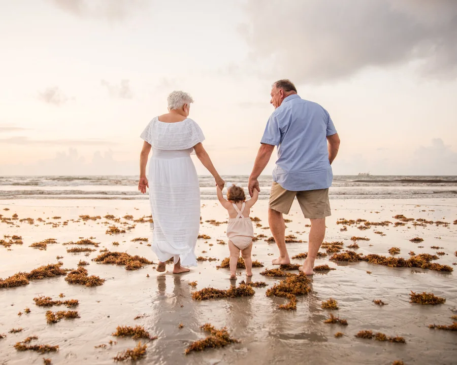 Family walking by the shoreline during a Cocoa Beach photography session