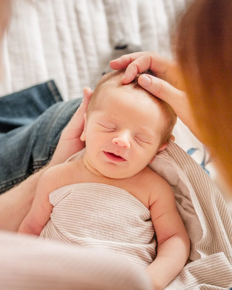 Parents holding their newborn during a calm Central Florida newborn session