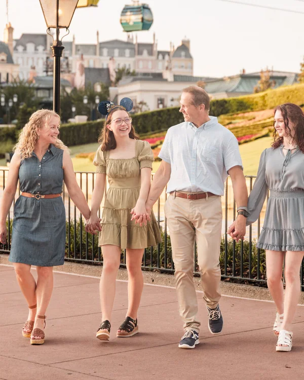 Family walking along a Disney-area resort boardwalk during an Orlando vacation