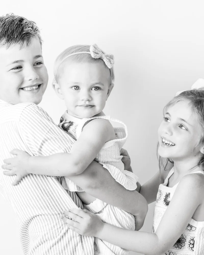 Children photographed together during a natural-light studio portrait session in Deltona