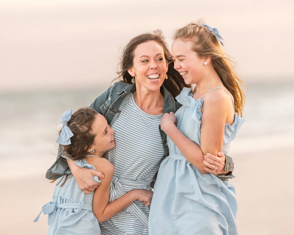 Mother and daughters laughing together during an Orlando family session